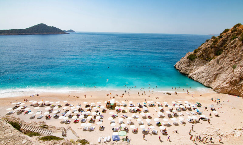 Tourists sunbathing and swimming on the Kaputas Beach, Kas, Antalya Turkey